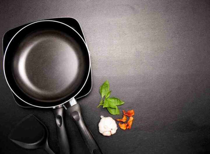 Top view frying pan and pot on black table